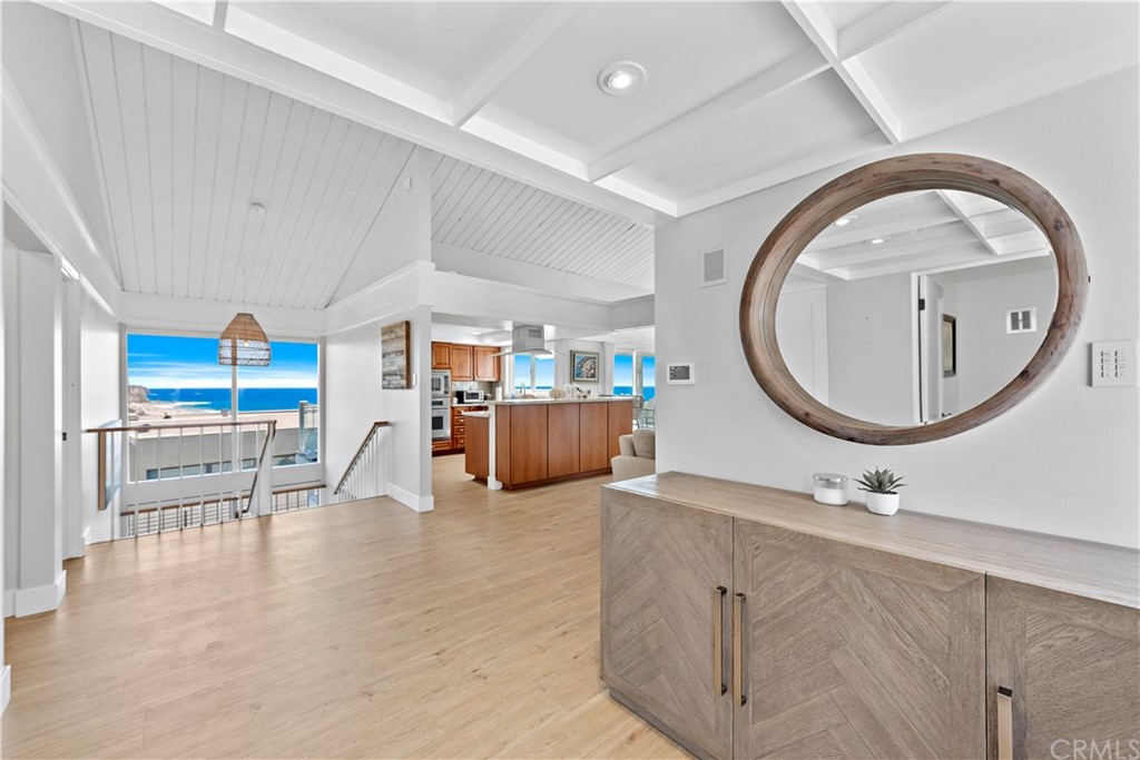 317 Monarch Bay Drive Dana Point, CA 92629 - Photo 7 of 26 wooden floor with a large window and kitchen view