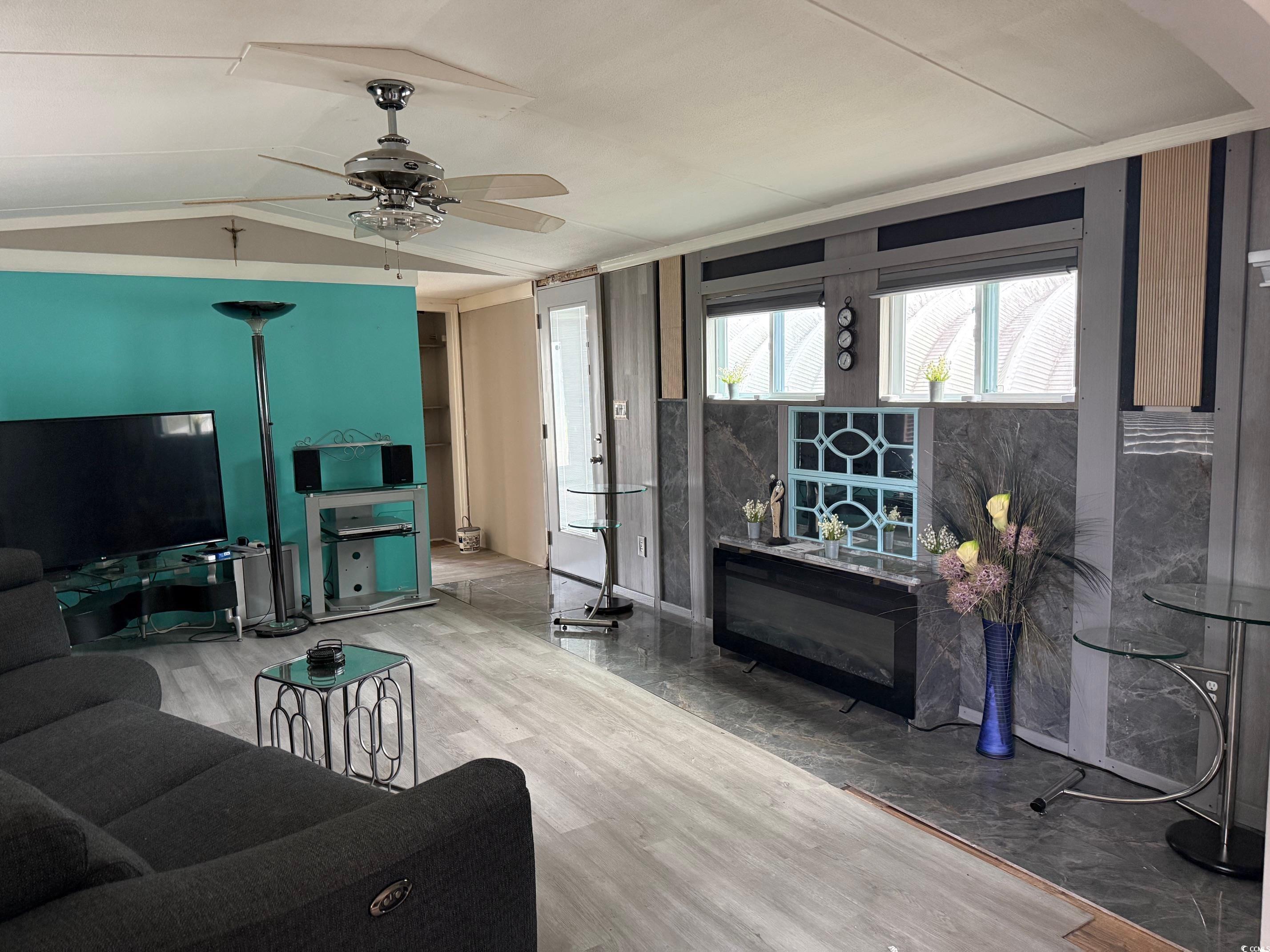 2709 Orion Drive Myrtle Beach, SC 29575 - Photo 12 of 27 Living room with vaulted ceiling, wood finished floors, and a ceiling fan