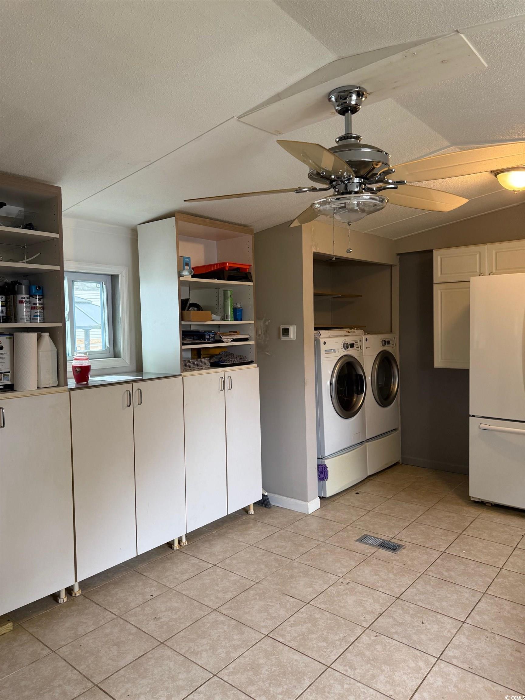 2709 Orion Drive Myrtle Beach, SC 29575 - Photo 16 of 27 Laundry area featuring a ceiling fan, a textured ceiling, washing machine and dryer, and light tile patterned floors