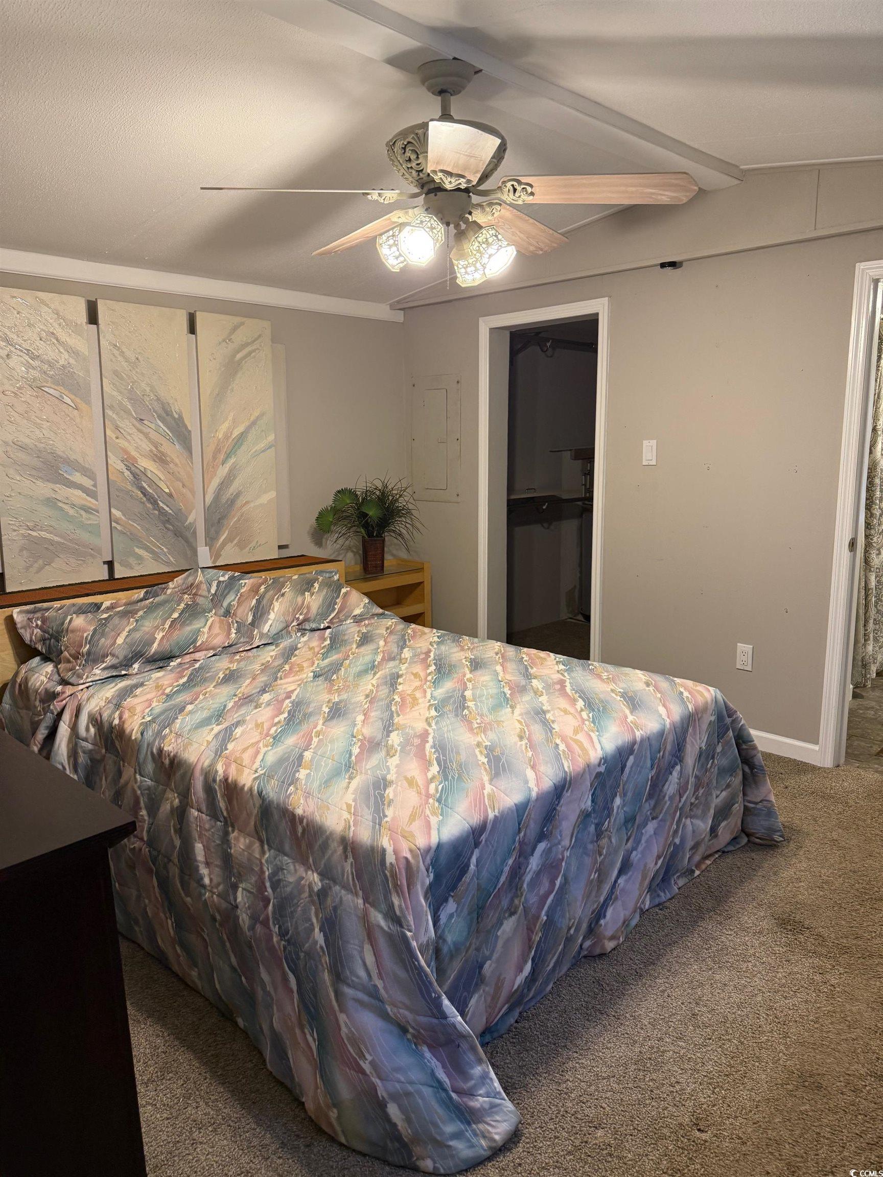 2709 Orion Drive Myrtle Beach, SC 29575 - Photo 17 of 27 Carpeted bedroom with a walk in closet, beamed ceiling, and ceiling fan