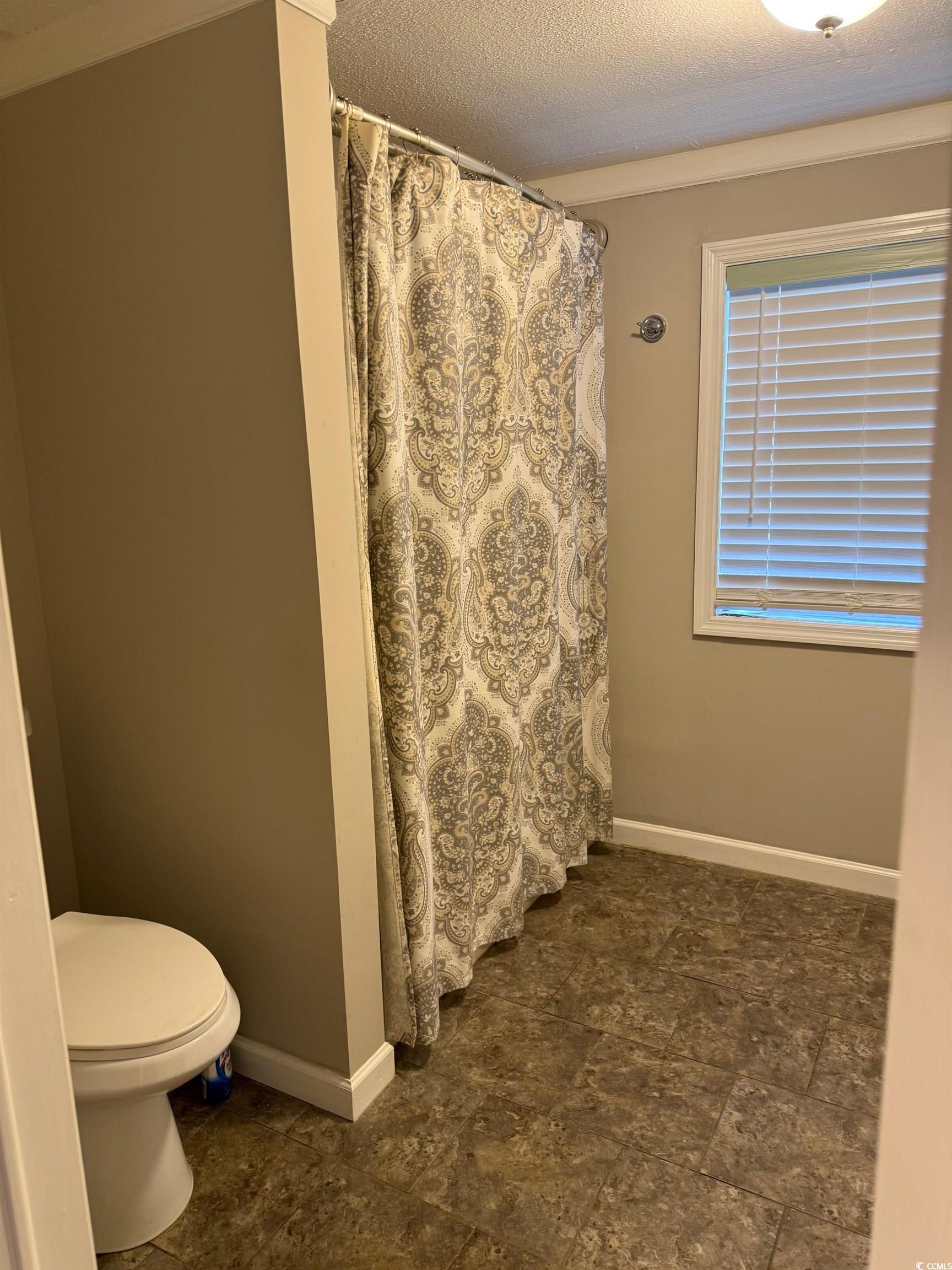 2709 Orion Drive Myrtle Beach, SC 29575 - Photo 20 of 27 Bathroom featuring a shower with curtain and a textured ceiling