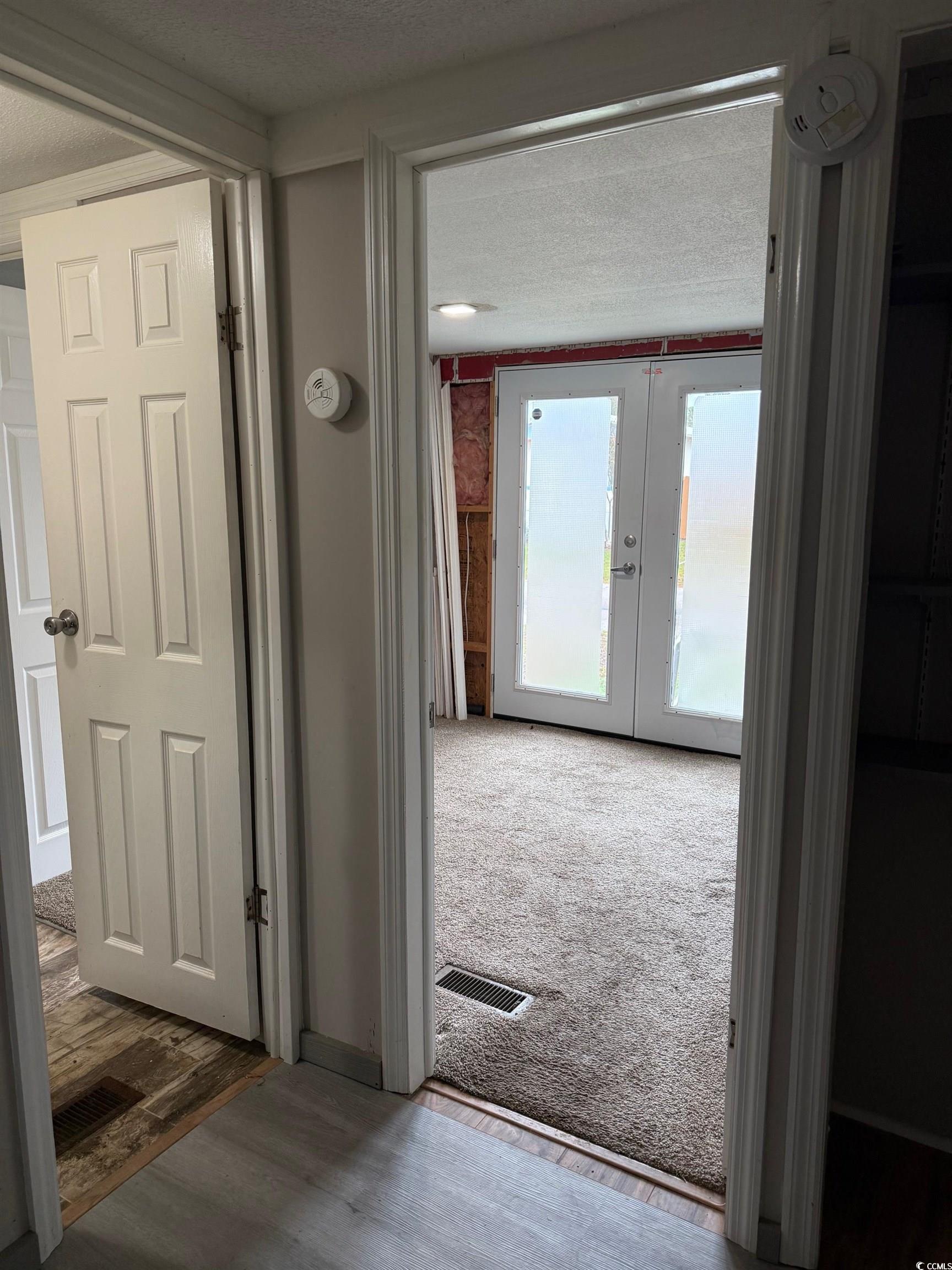 2709 Orion Drive Myrtle Beach, SC 29575 - Photo 22 of 27 Entryway with wood finished floors, a textured ceiling, and french doors