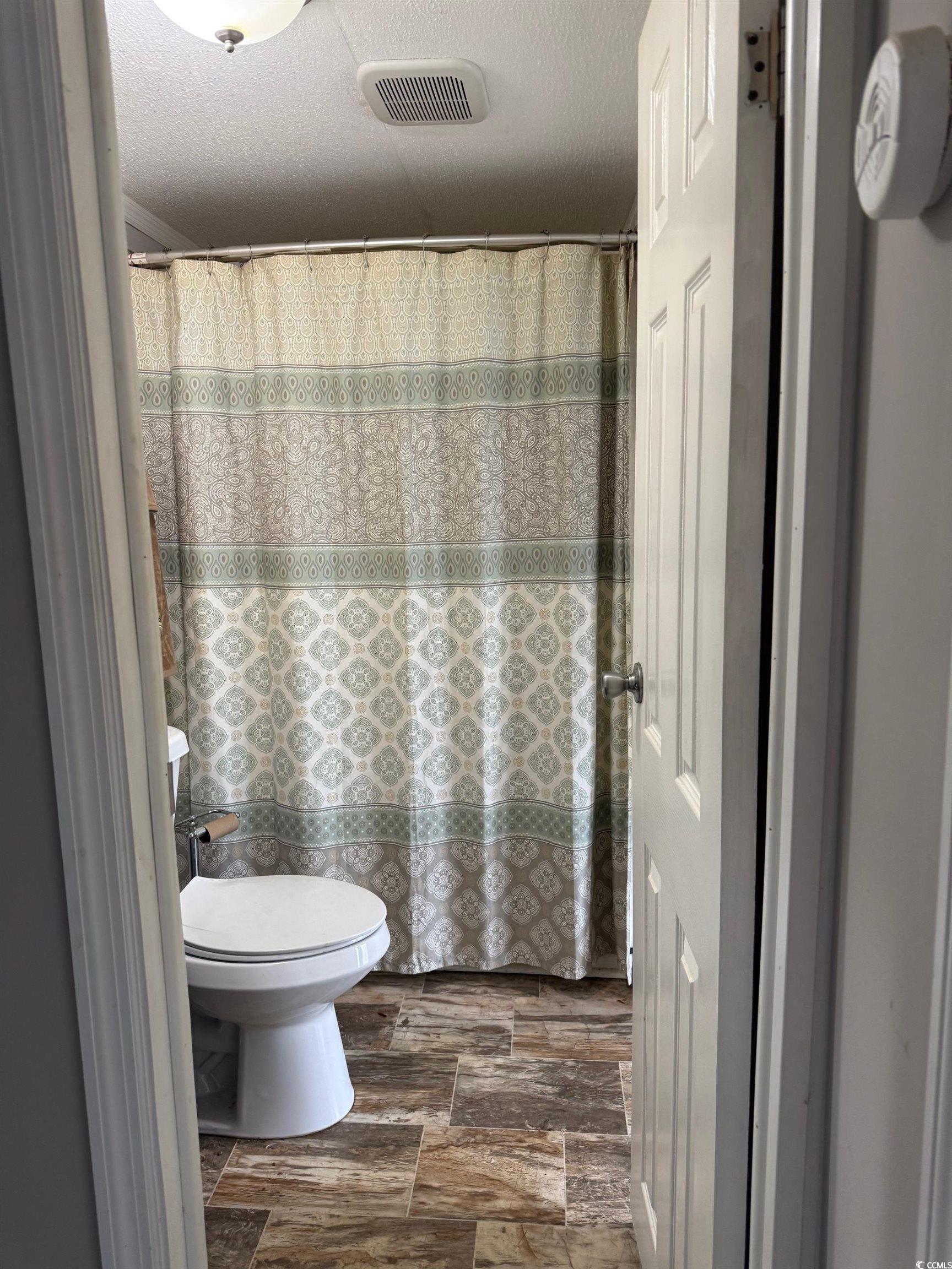 2709 Orion Drive Myrtle Beach, SC 29575 - Photo 27 of 27 Full bathroom with curtained shower and a textured ceiling