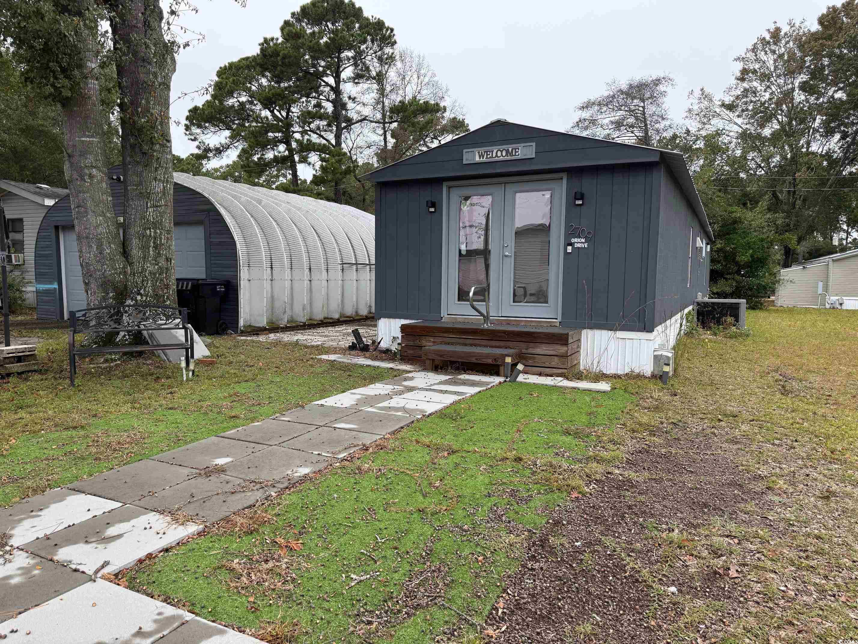 2709 Orion Drive Myrtle Beach, SC 29575 - Photo 4 of 27 View of front of home with an outdoor structure, a front yard, and entry steps