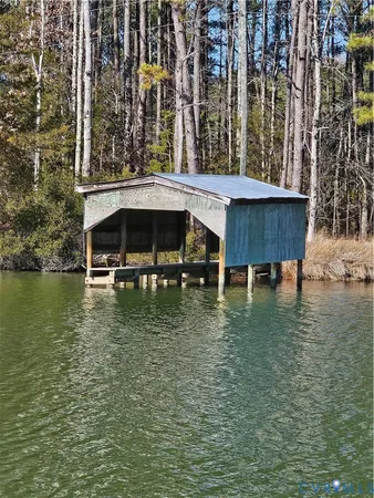 a view of swimming pool with outdoor seating and lake view