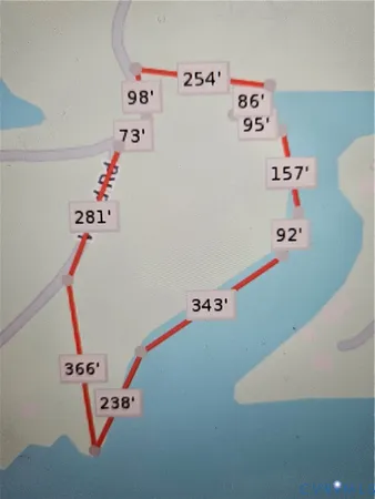 a room with a refrigerator and a dresser