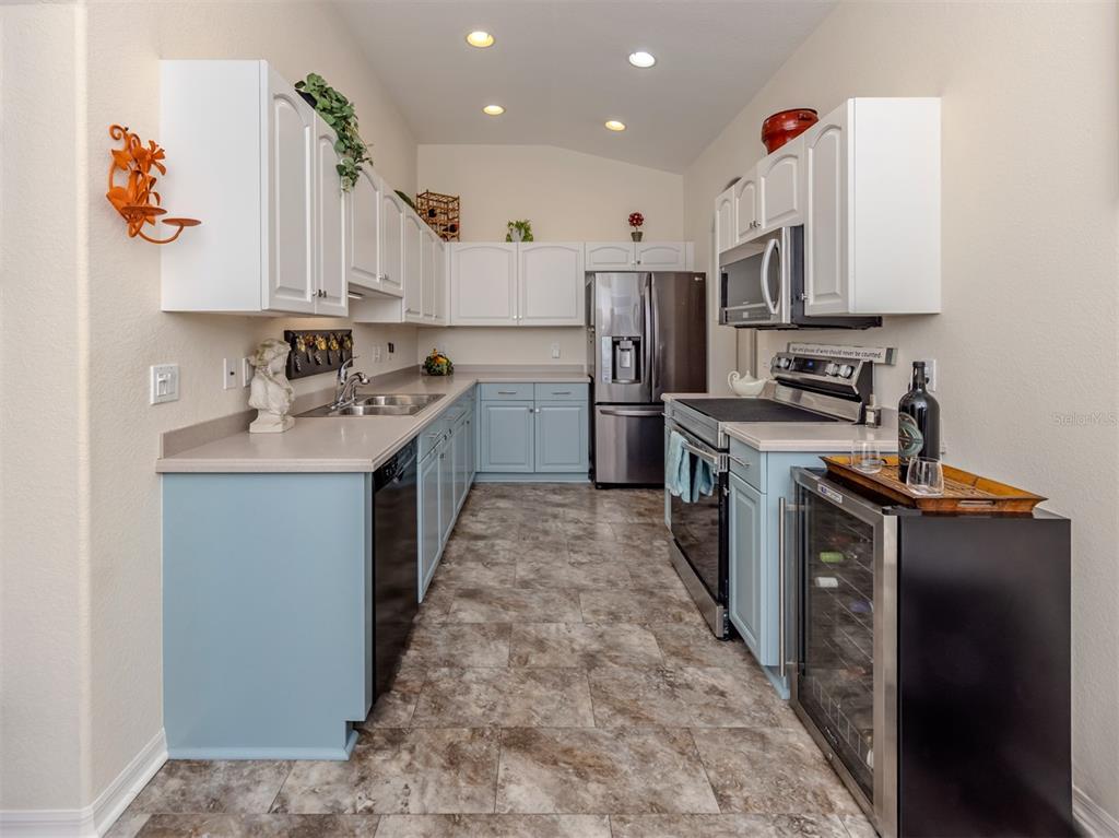 205 Reclinata Circle Venice, FL 34292 - Photo 19 of 62 a kitchen with stainless steel appliances granite countertop a sink stove and refrigerator
