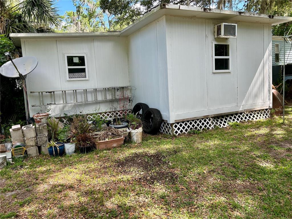 25646 Bass Road Astor, FL 32102 - Photo 43 of 48 a front view of a house with a yard