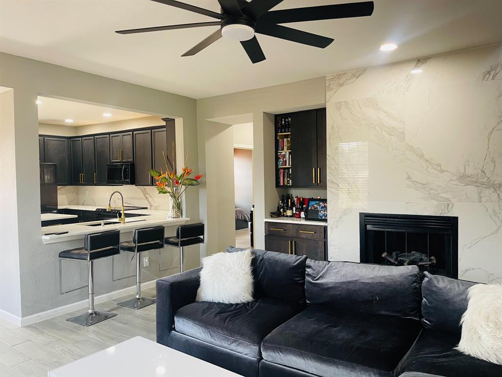 516 Angela Lane Euless, TX 76039 - Photo 6 of 39 Living area with recessed lighting, light wood finished floors, a ceiling fan, and a fireplace