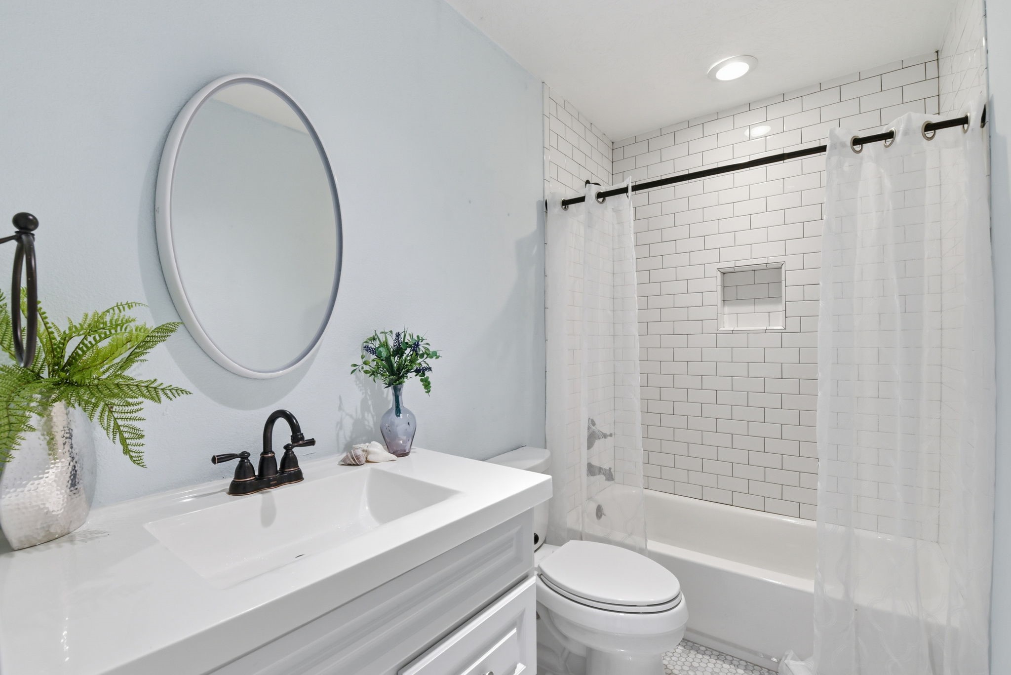 180 Grove Road Kemah, TX 77565 - Photo 17 of 30 Experience modern elegance in this primary bathroom, featuring sleek fixtures, a chic subway-tiled shower, and a bright, airy ambiance.