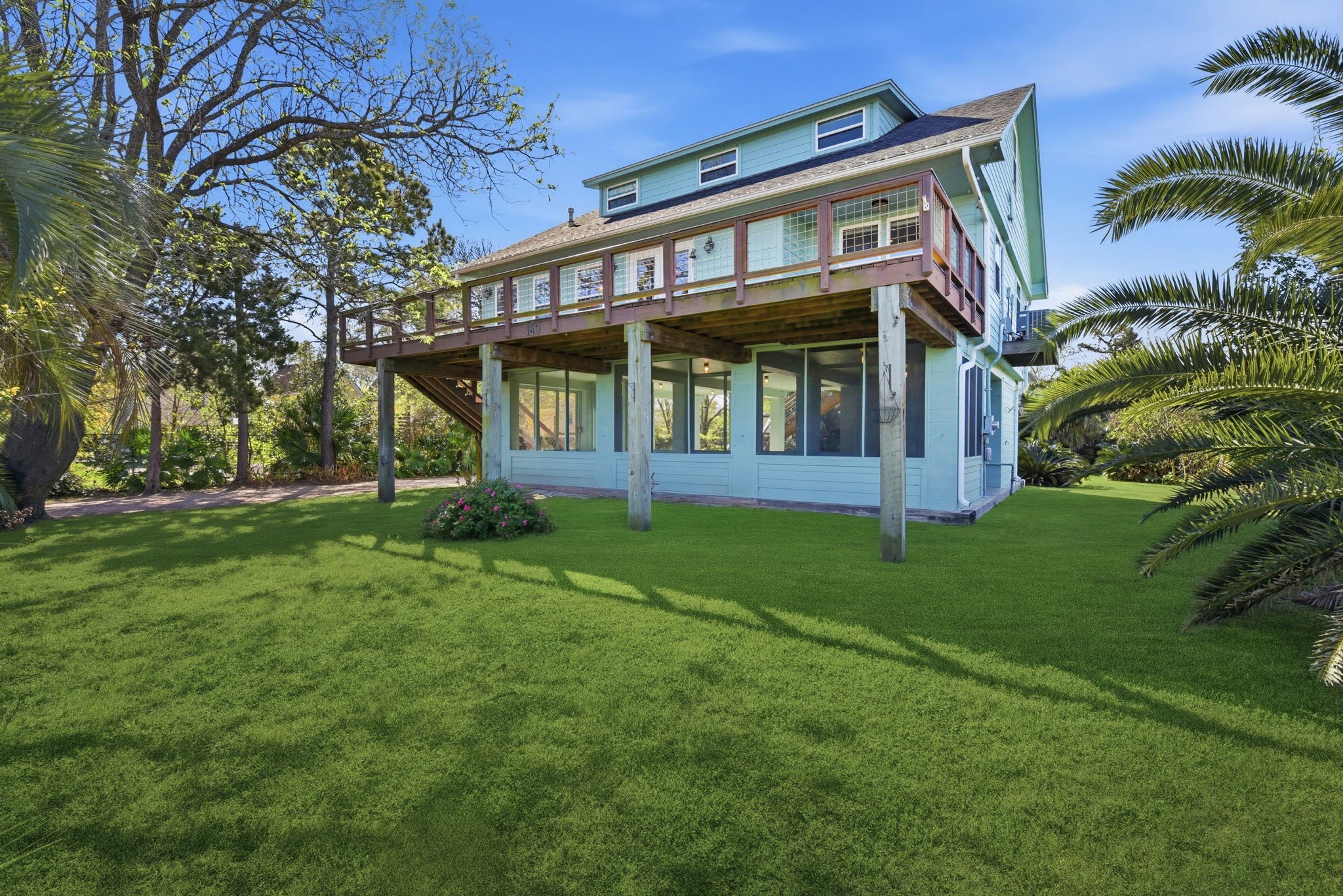 180 Grove Road Kemah, TX 77565 - Photo 2 of 30 Discover unparalleled outdoor living in this home, featuring an expansive yard perfect for storing boats, RVs and other toys.