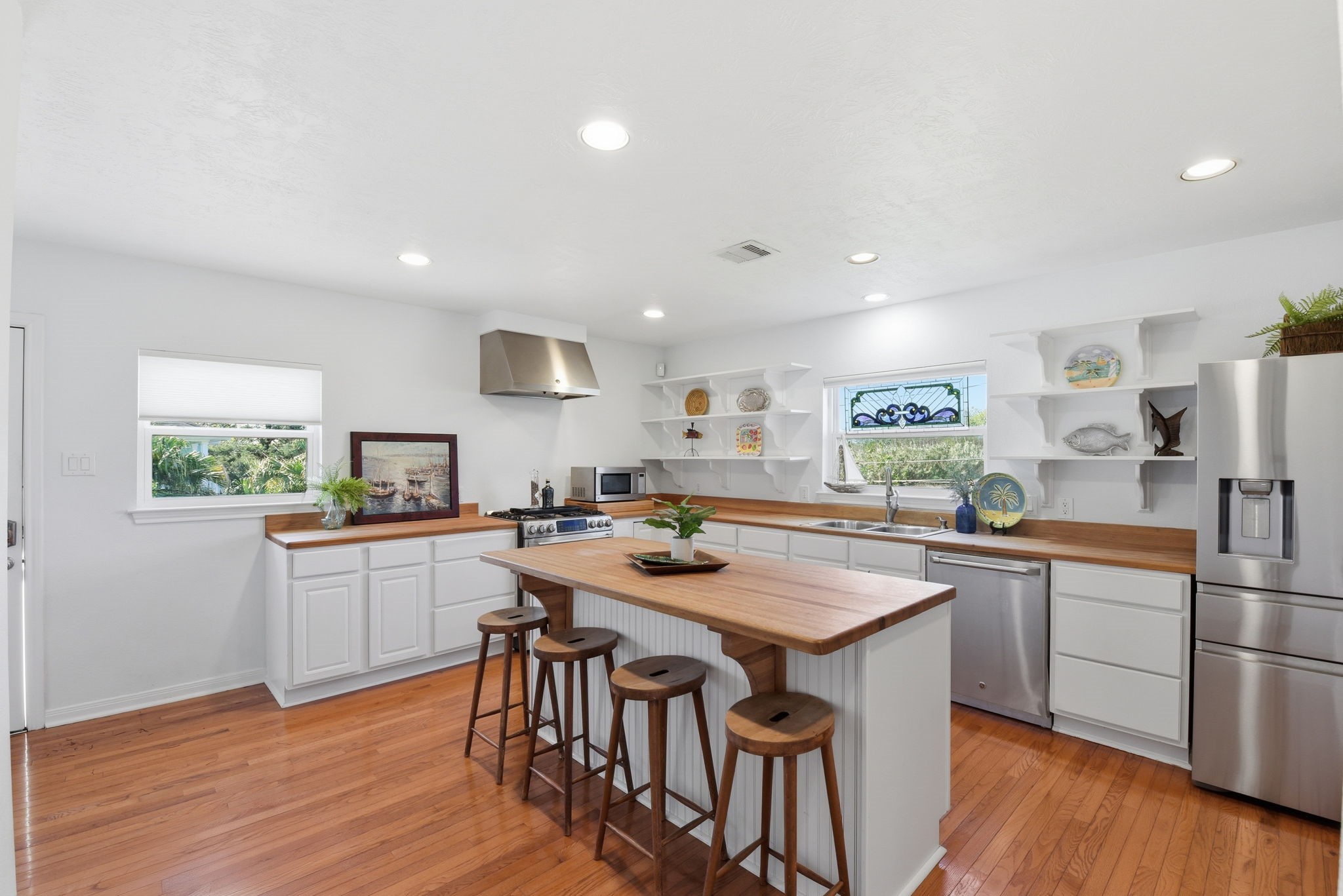 180 Grove Road Kemah, TX 77565 - Photo 10 of 30 Step into the inviting kitchen where a stylish breakfast bar with a beautiful butcher block top awaits, perfect for casual dining and entertaining.