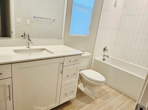 a bathroom with a sink toilet vanity and shower