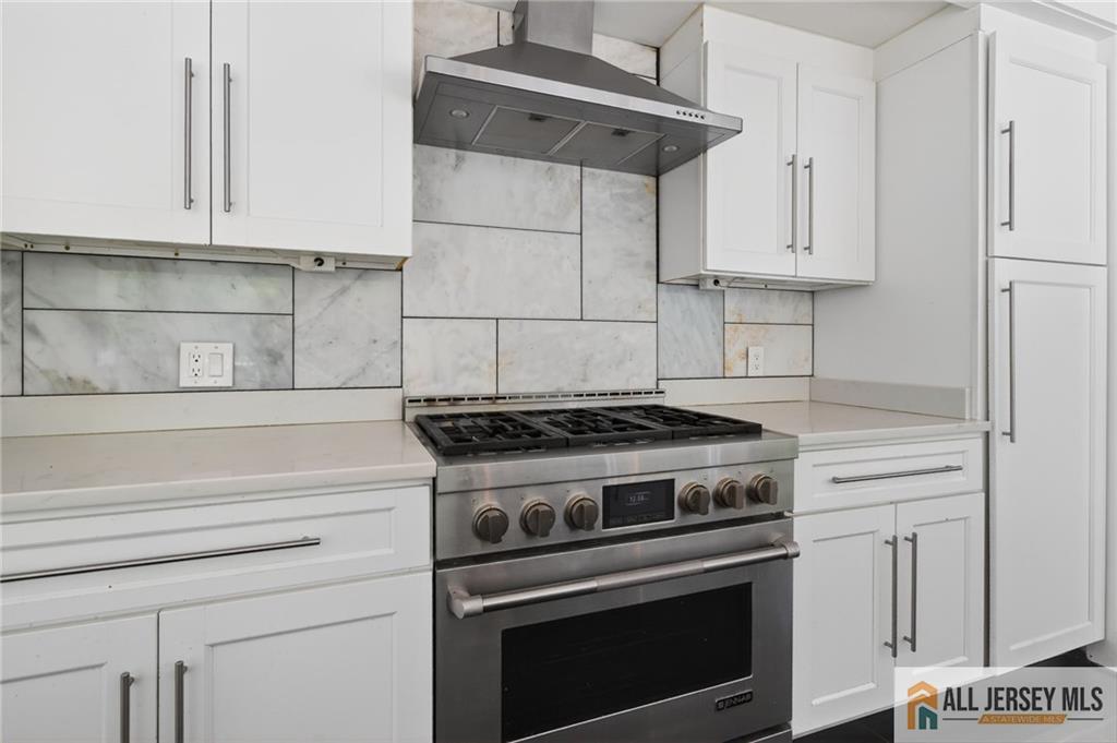 381 Monmouth Road Freehold, NJ 07728 - Photo 18 of 63 a stove top oven sitting inside of a kitchen