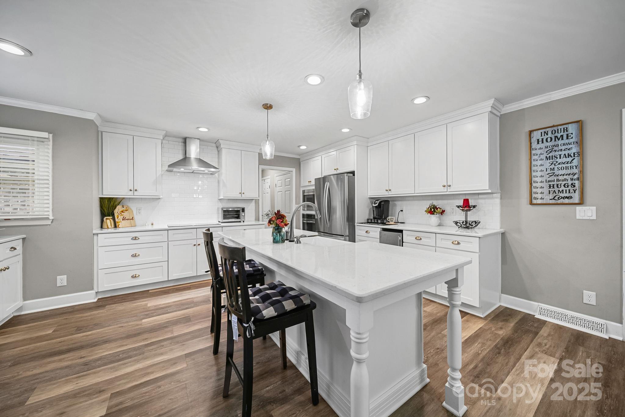 4724 Weddington Matthews Road Matthews, NC 28104 - Photo 12 of 42 a kitchen with stainless steel appliances a stove a sink a refrigerator white cabinets and wooden floor