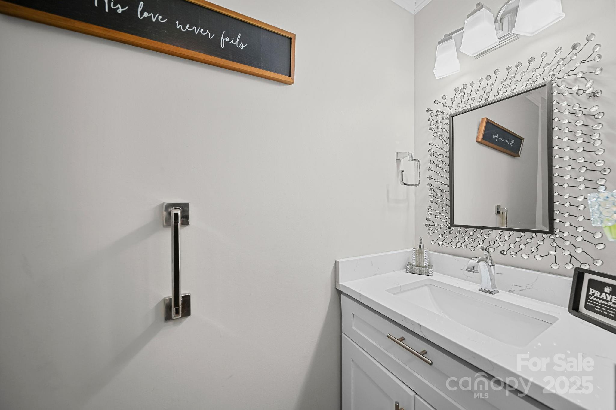 4724 Weddington Matthews Road Matthews, NC 28104 - Photo 13 of 42 a bathroom with a sink a vanity and a mirror