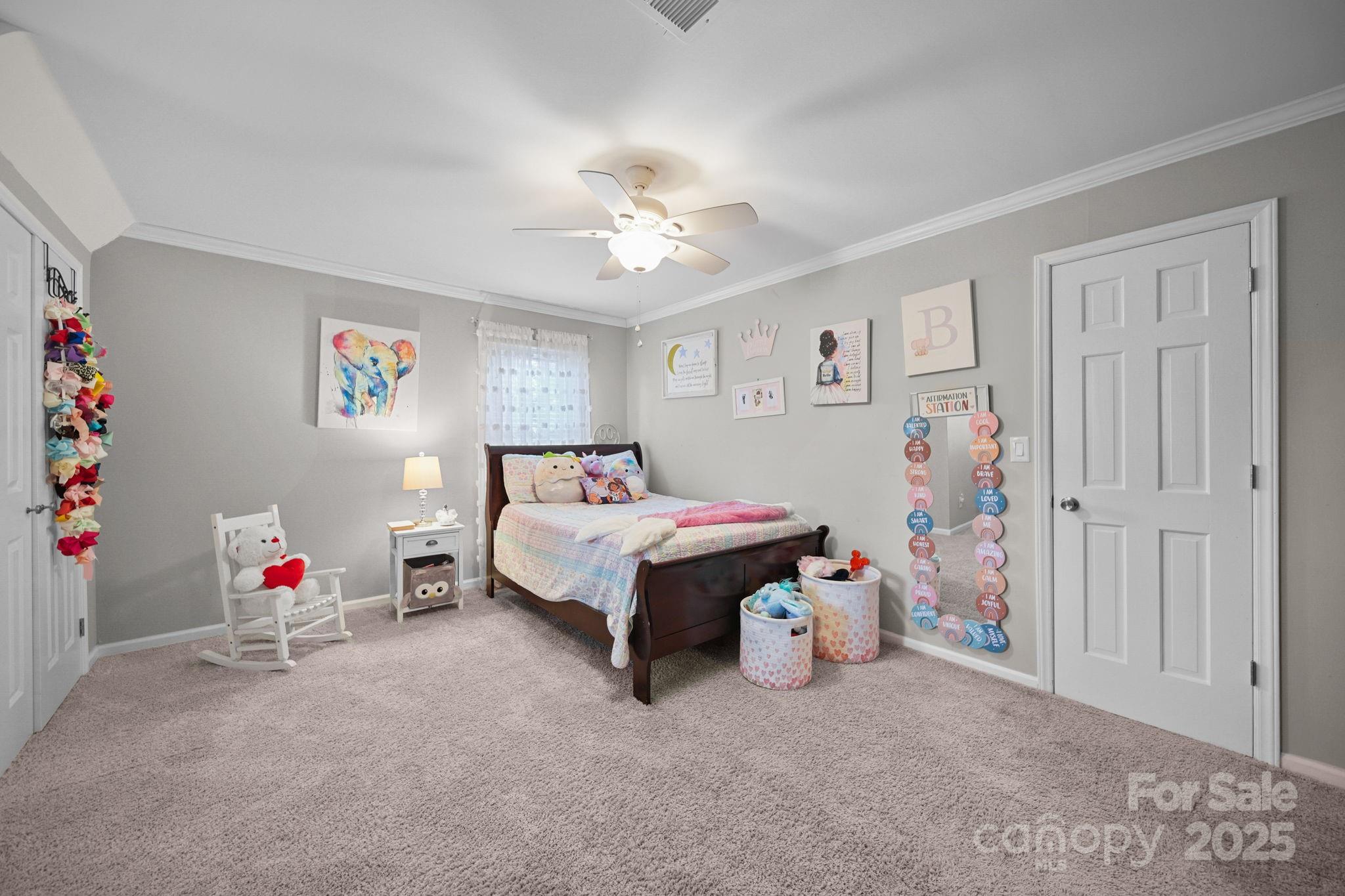 4724 Weddington Matthews Road Matthews, NC 28104 - Photo 20 of 42 a bedroom with a bed and a chandelier