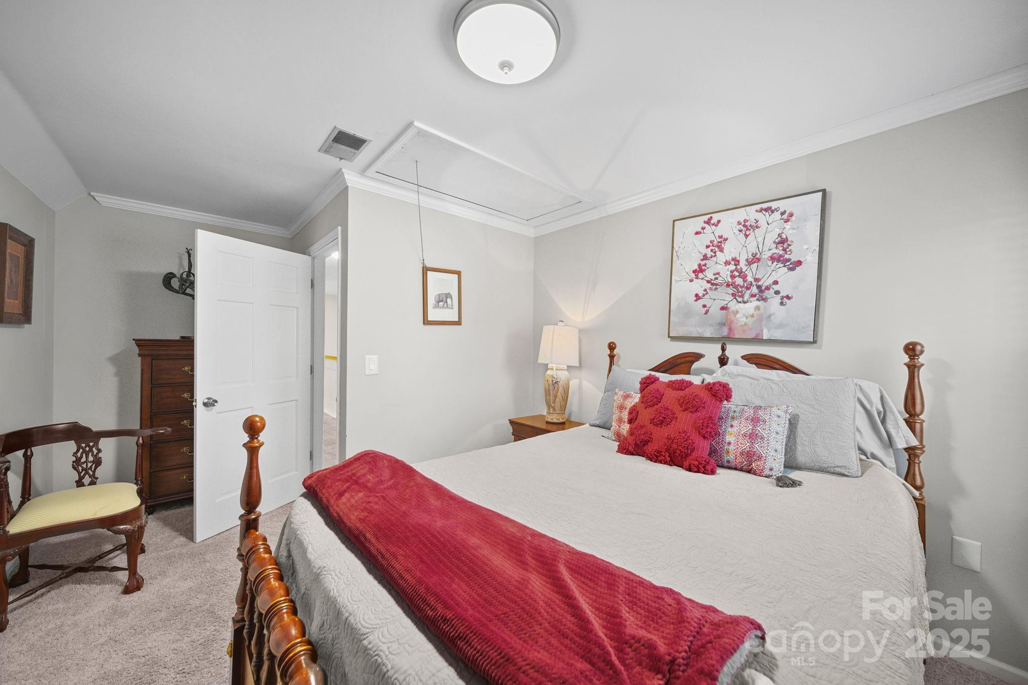 4724 Weddington Matthews Road Matthews, NC 28104 - Photo 23 of 42 a bedroom with a bed and a chandelier