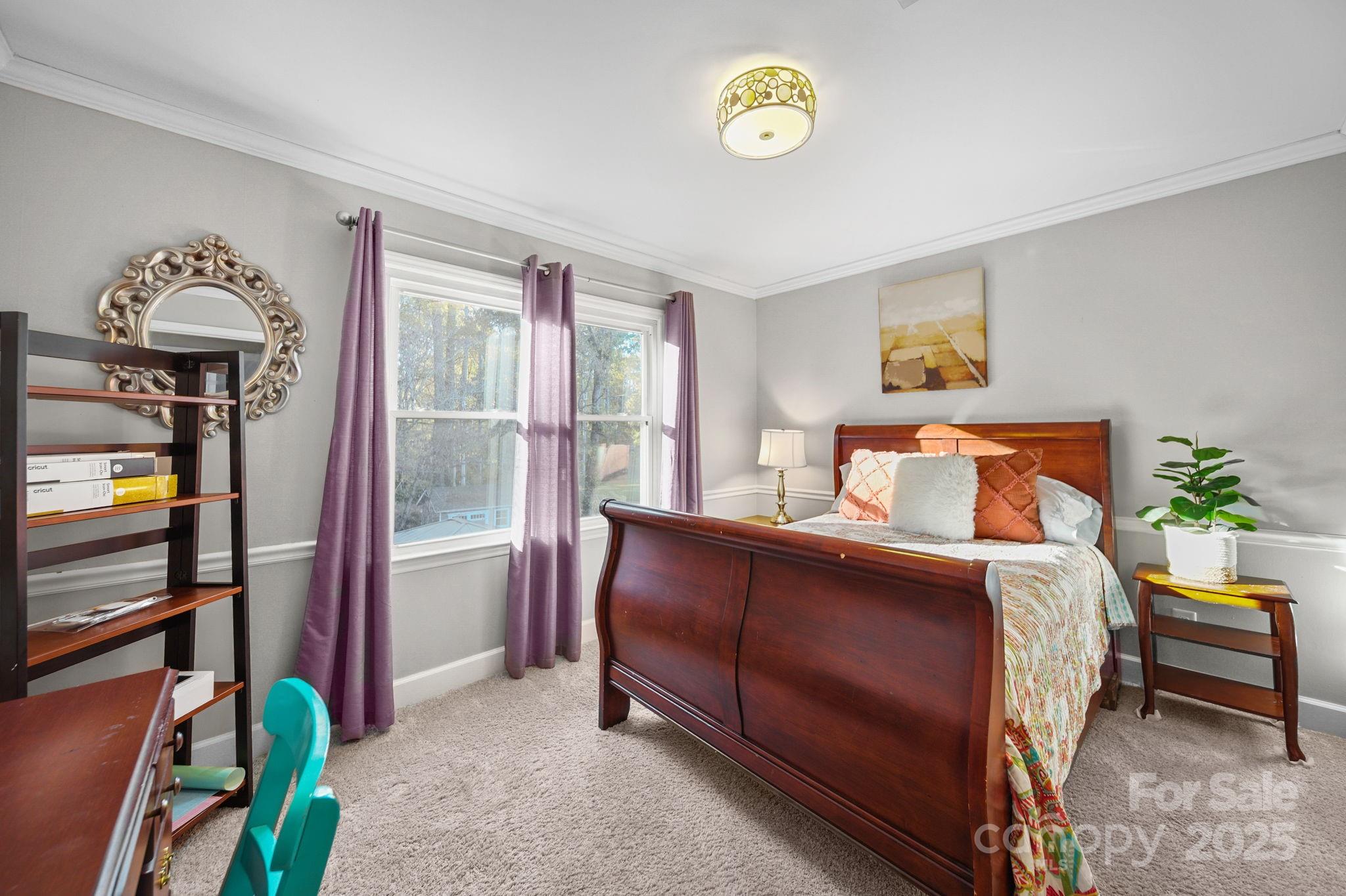 4724 Weddington Matthews Road Matthews, NC 28104 - Photo 24 of 42 a bedroom with a bed and a chandelier