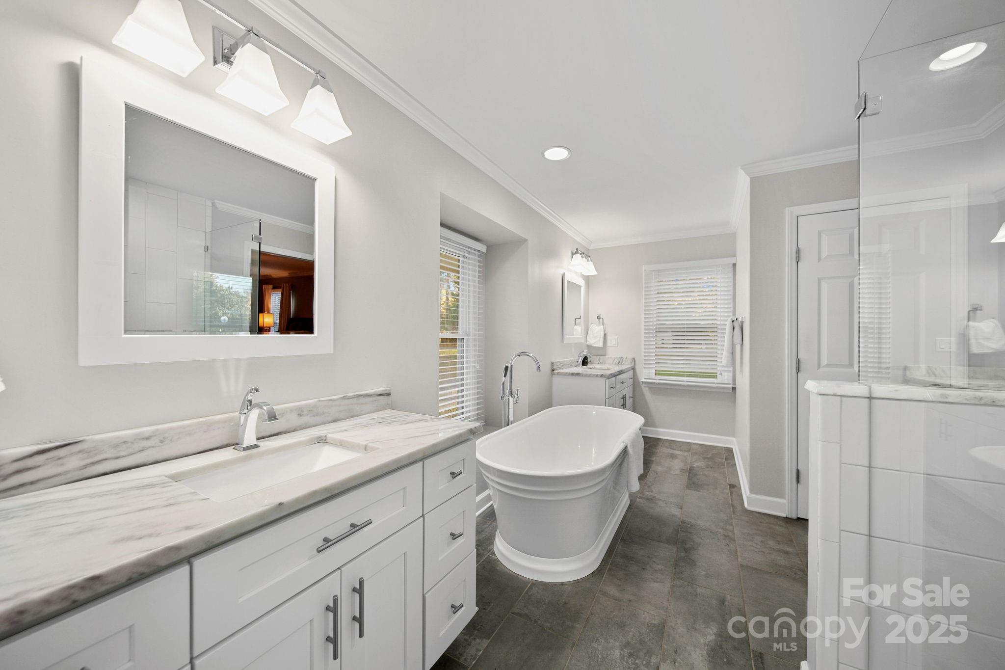 4724 Weddington Matthews Road Matthews, NC 28104 - Photo 33 of 42 a bathroom with a double vanity sink a mirror and a toilet