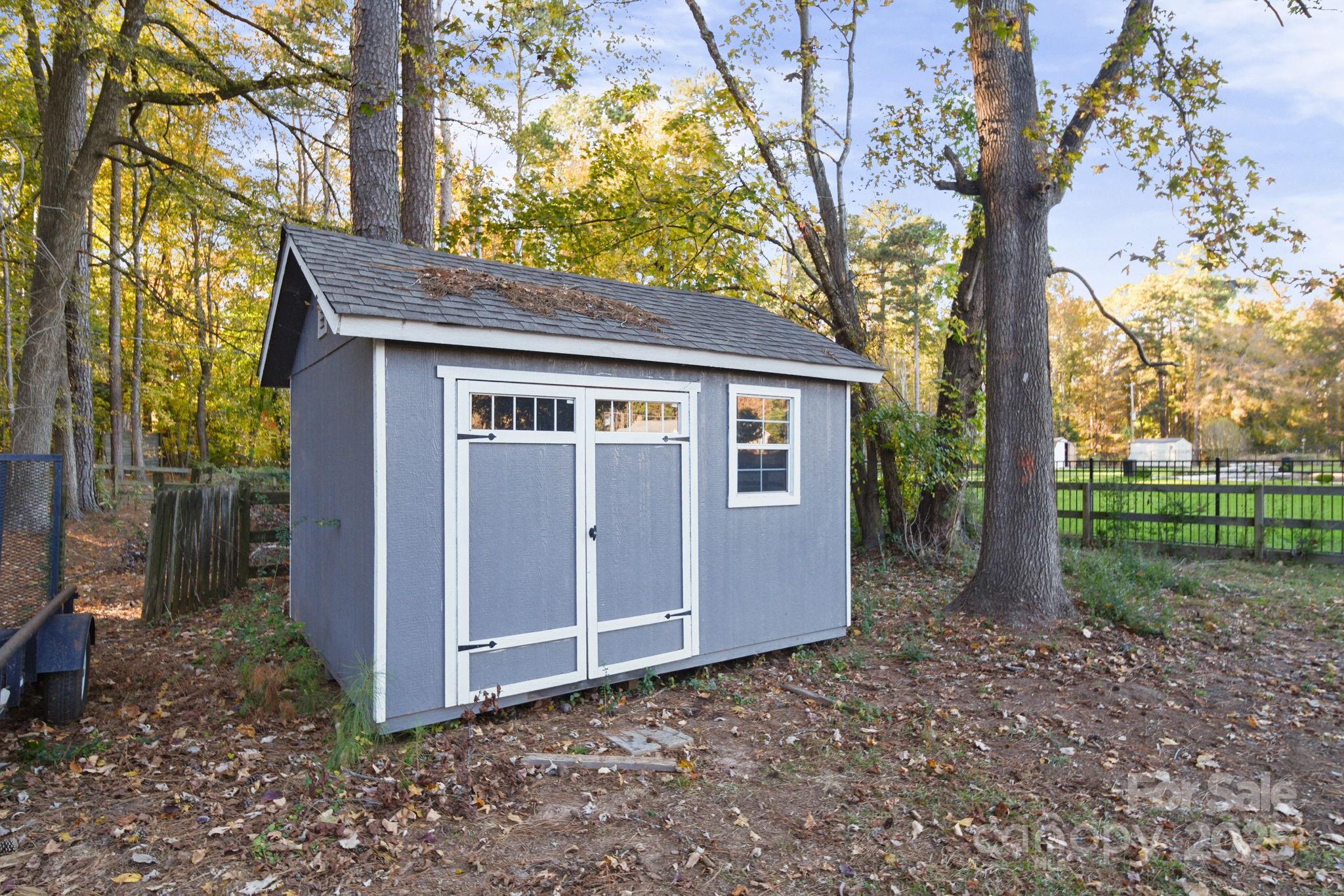 4724 Weddington Matthews Road Matthews, NC 28104 - Photo 40 of 42 a house with trees in front of it