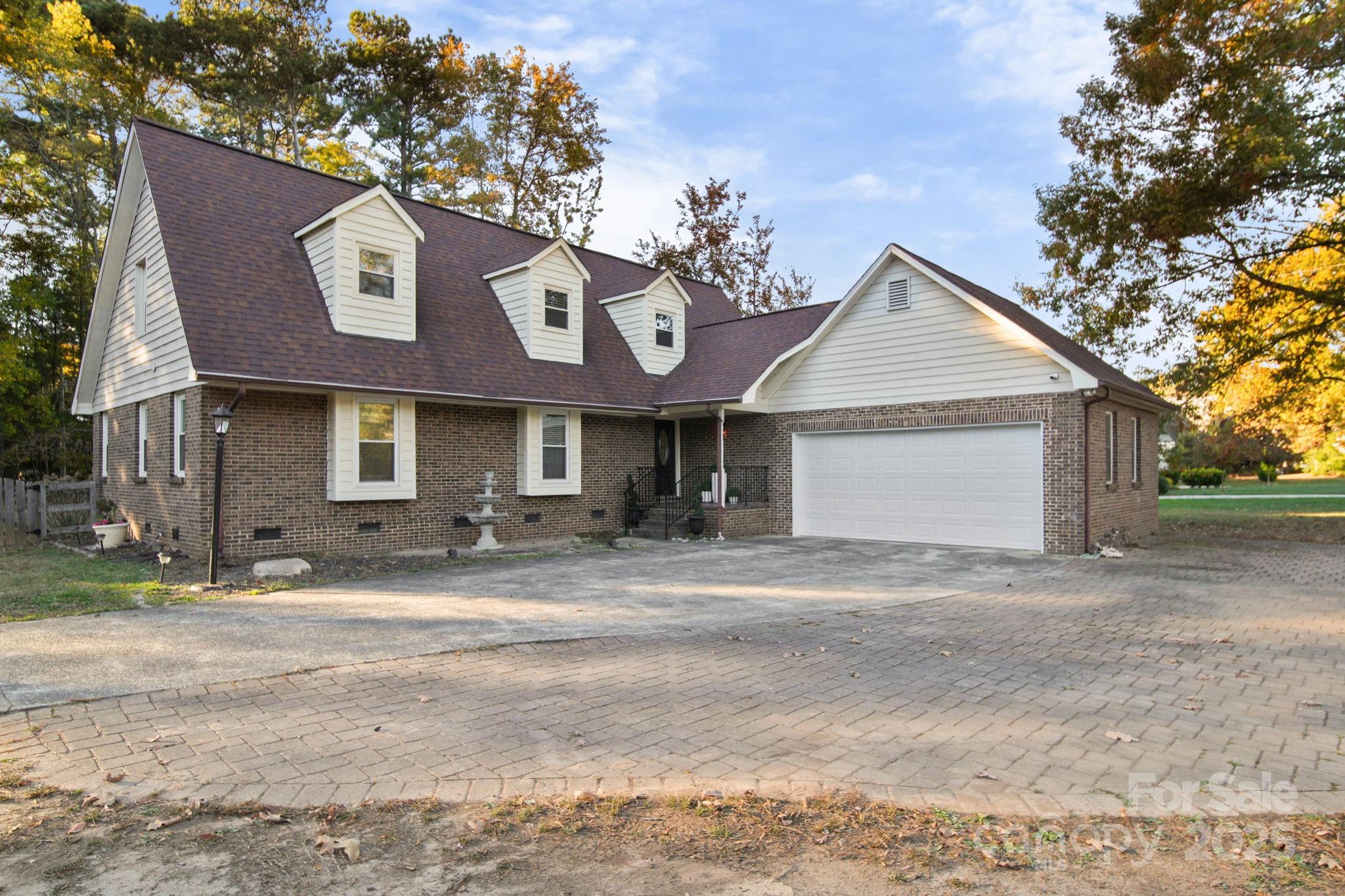 4724 Weddington Matthews Road Matthews, NC 28104 - Photo 4 of 42 a front view of a house with a yard and garage