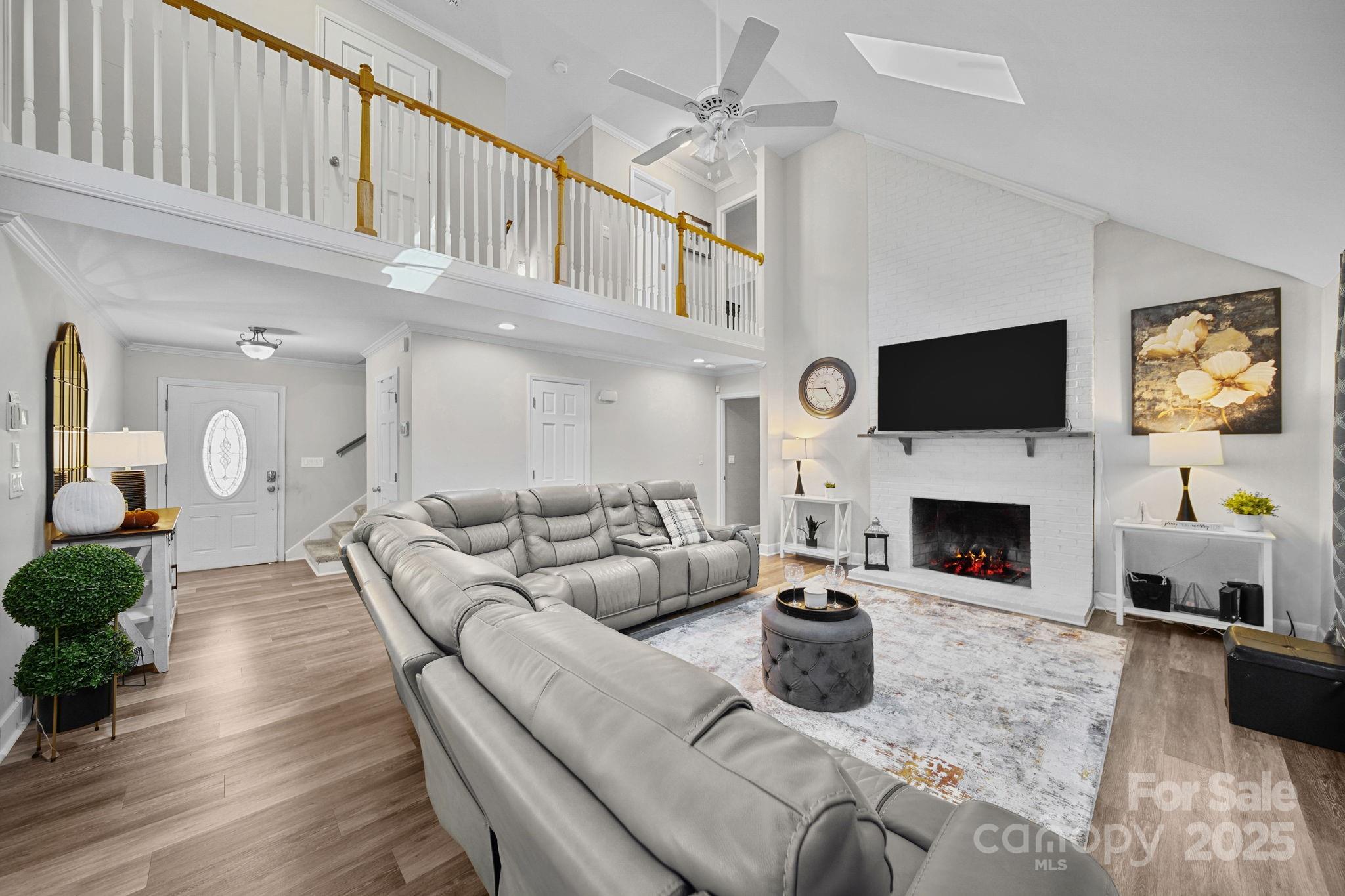 4724 Weddington Matthews Road Matthews, NC 28104 - Photo 5 of 42 a living room with furniture a fireplace and a flat screen tv