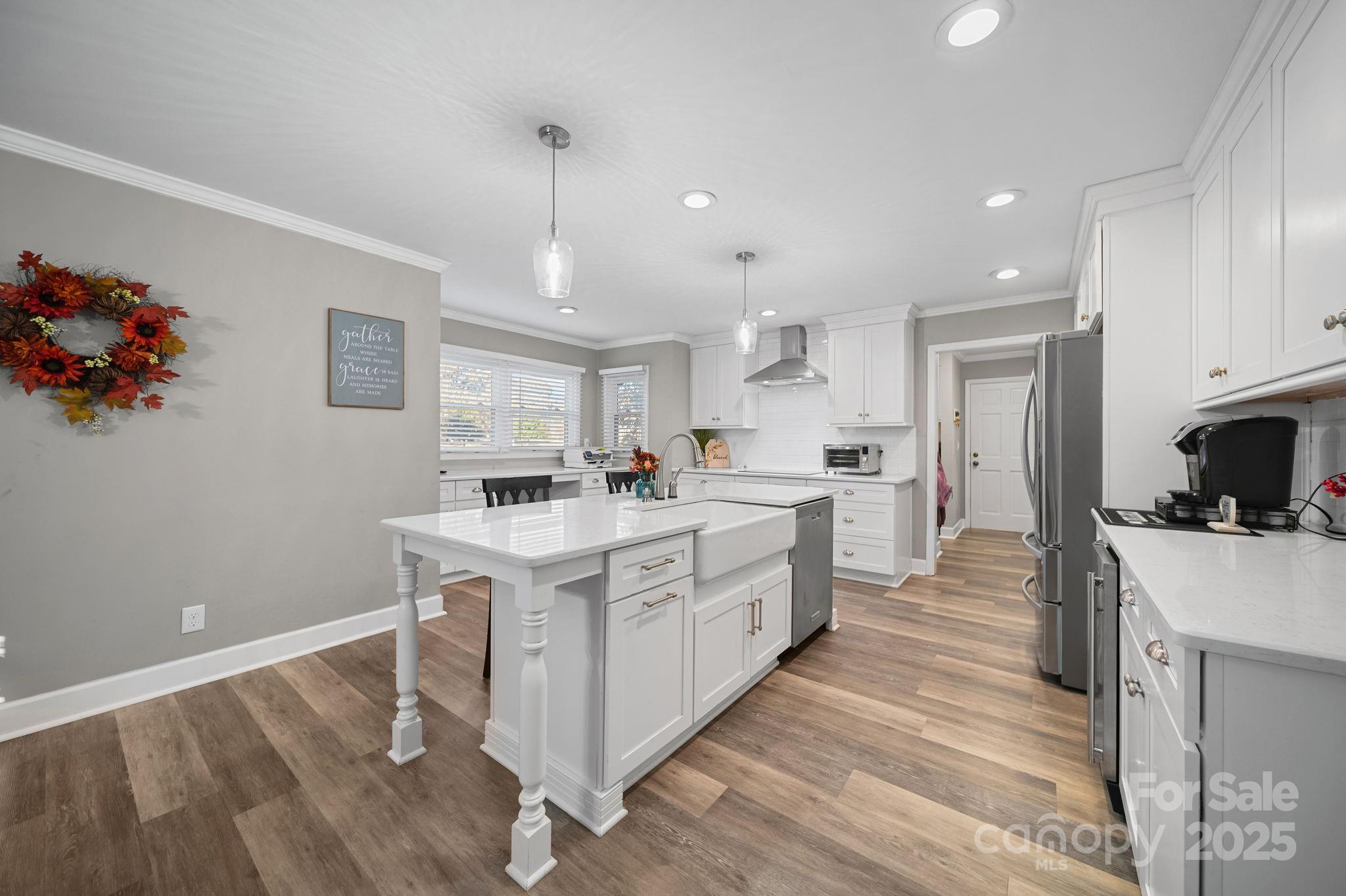4724 Weddington Matthews Road Matthews, NC 28104 - Photo 10 of 42 a kitchen with white cabinets and stainless steel appliances
