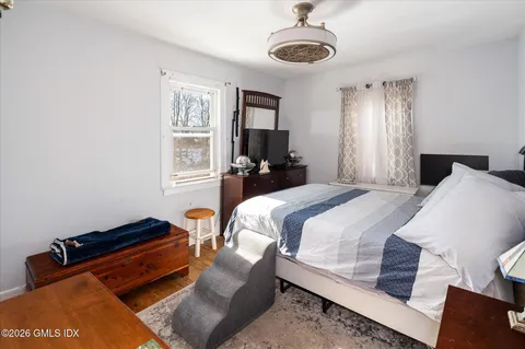 a bedroom with bed and window