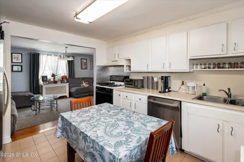 a kitchen with stainless steel appliances kitchen island granite countertop a sink stove and cabinets