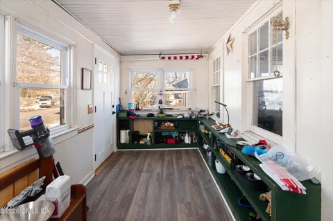 a very nice looking room with many windows and furniture