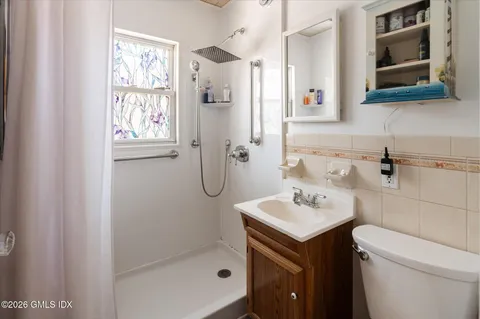 a bathroom with a sink toilet and shower