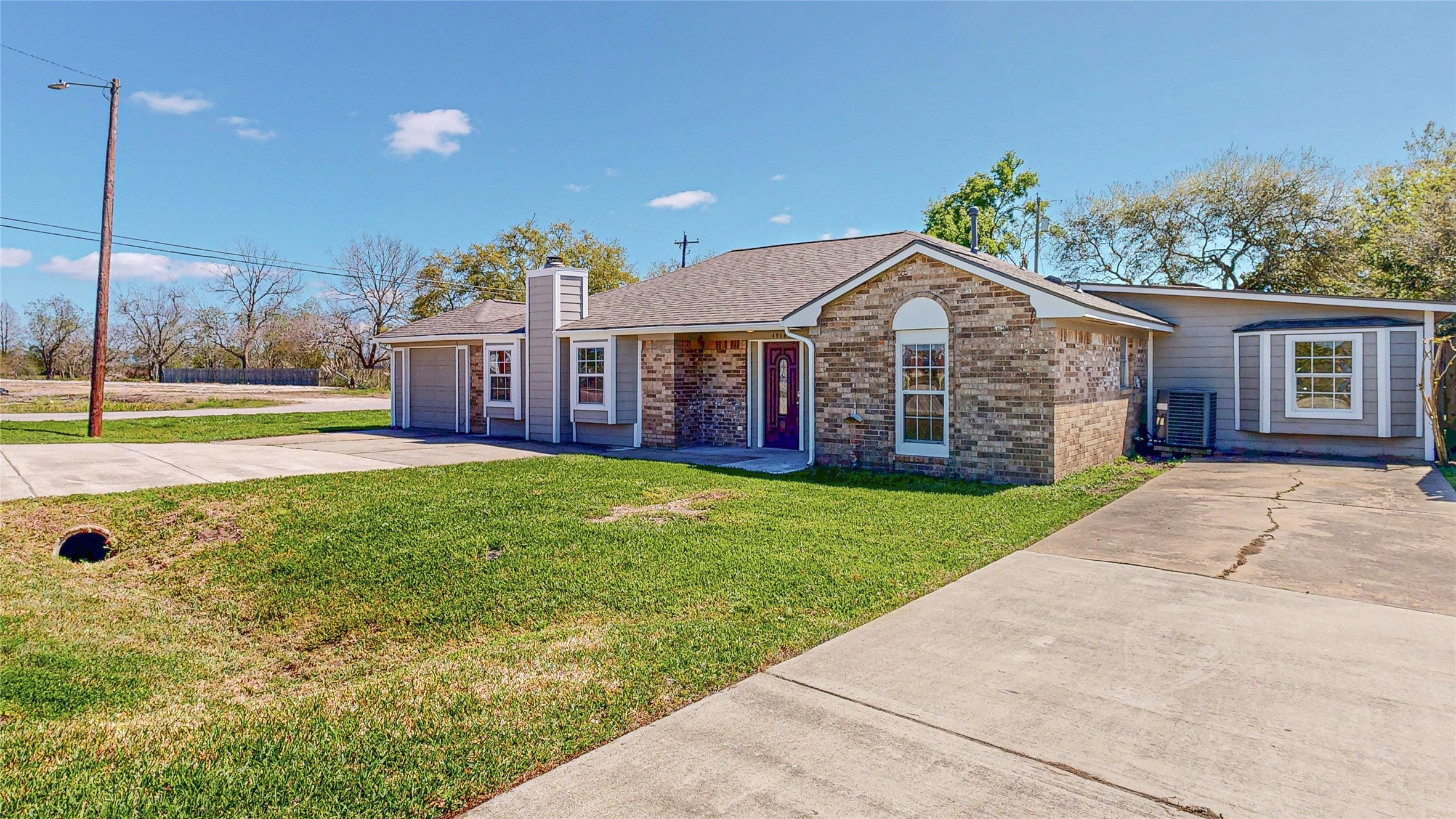 4914 29th Street Dickinson, TX 77539 - Photo 5 of 28 Front Side View of the Property Displaying Both Driveways.