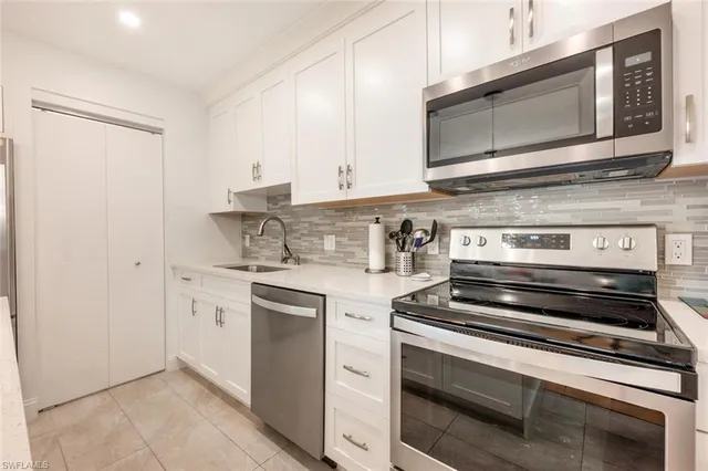 a kitchen with stainless steel appliances granite countertop a stove and a microwave
