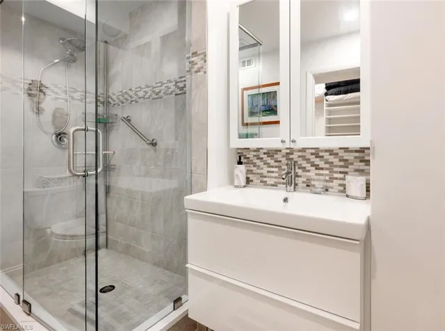 a bathroom with a shower and a sink