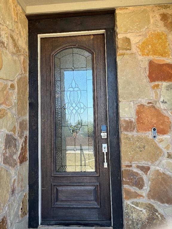 Undisclosed Address Dripping Springs, TX 78620 - Photo 2 of 19 Property entrance featuring stone siding