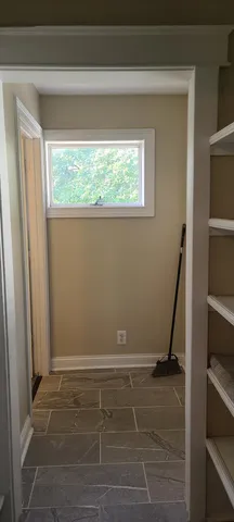 a view of a room with wooden floor and a window