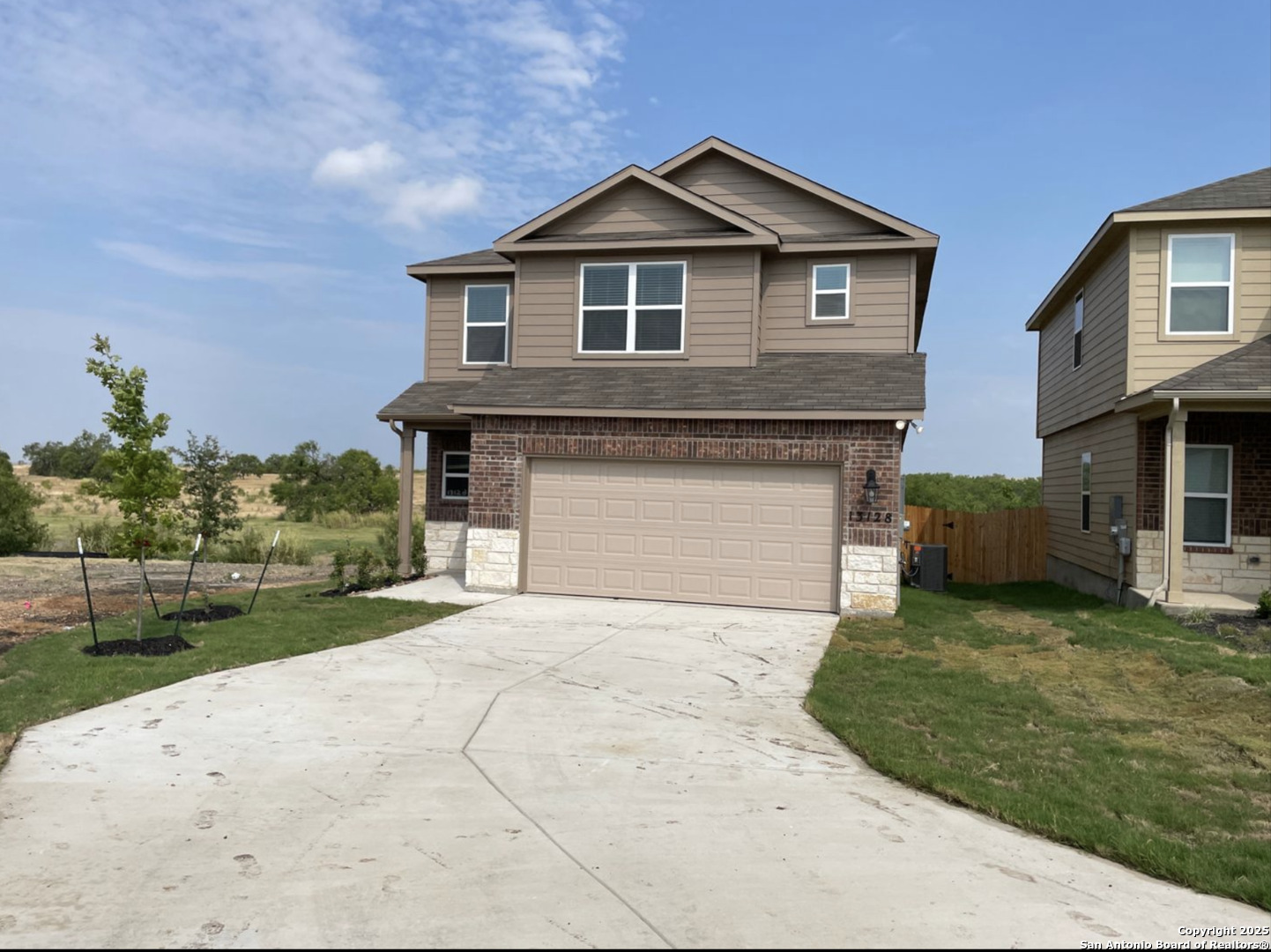 13128 Candace Way St. Hedwig, TX 78152 - Photo 1 of 14 a front view of a house with a yard and garage