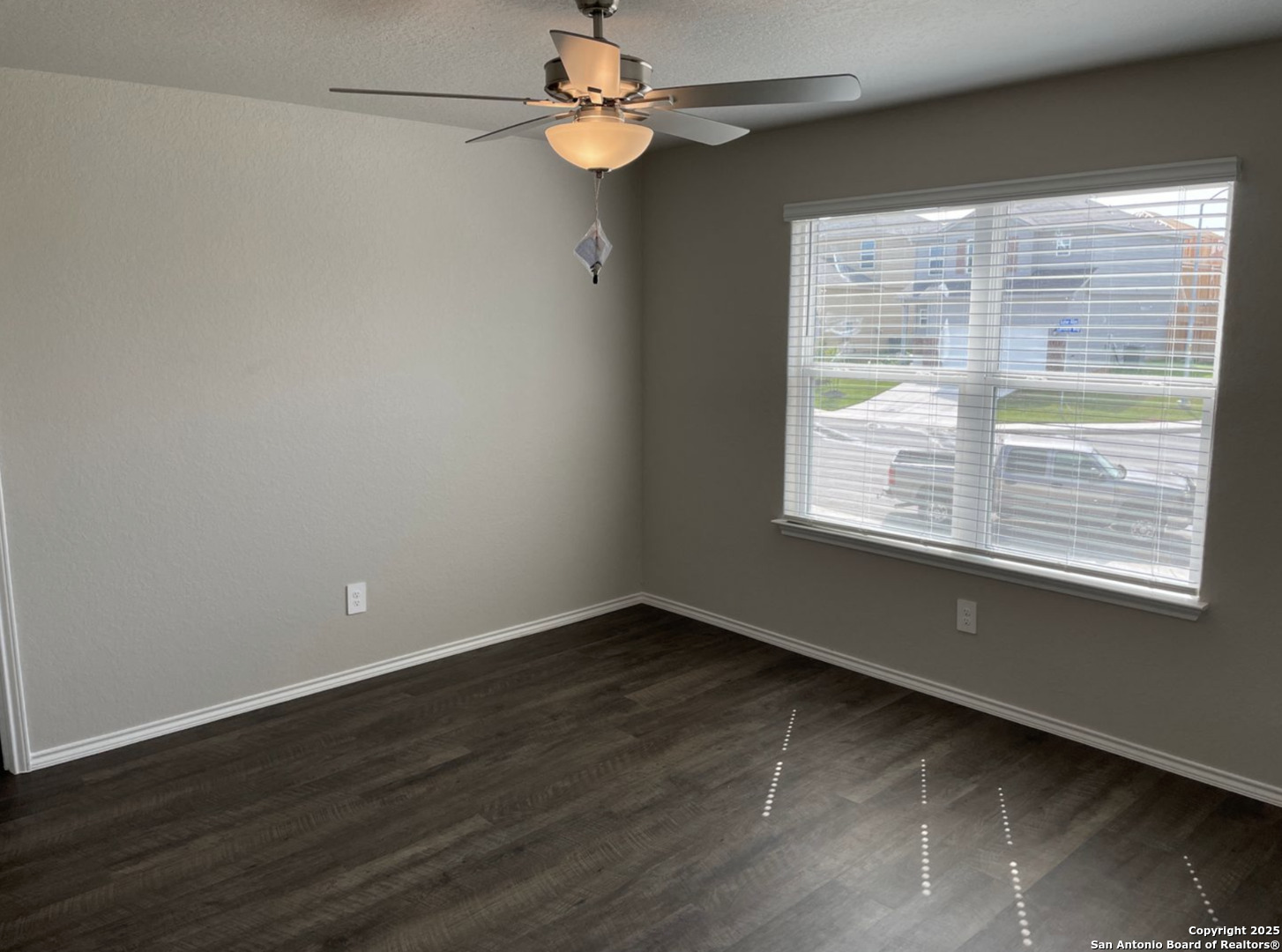 13128 Candace Way St. Hedwig, TX 78152 - Photo 3 of 14 a view of empty room with wooden floor and fan