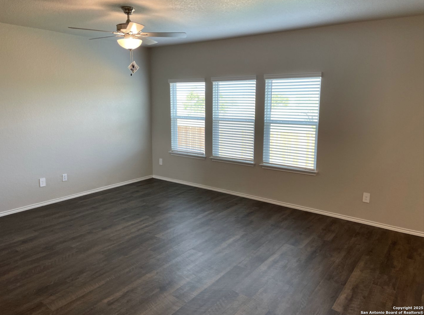 13128 Candace Way St. Hedwig, TX 78152 - Photo 4 of 14 a view of an empty room with wooden floor and a window