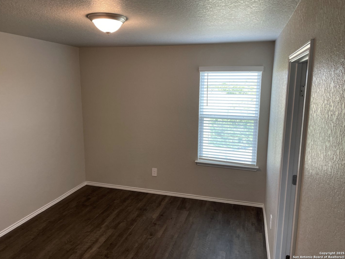 13128 Candace Way St. Hedwig, TX 78152 - Photo 6 of 14 an empty room with wooden floor and windows