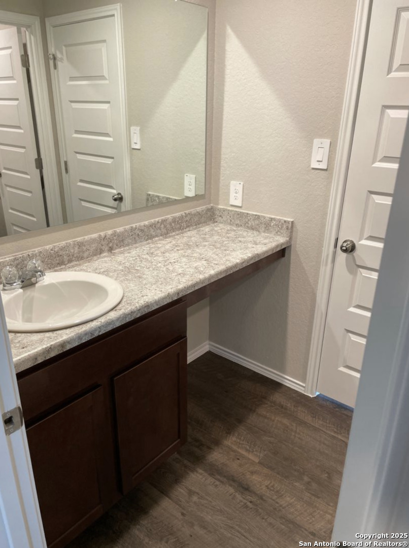 13128 Candace Way St. Hedwig, TX 78152 - Photo 8 of 14 a bathroom with a granite countertop sink and a mirror