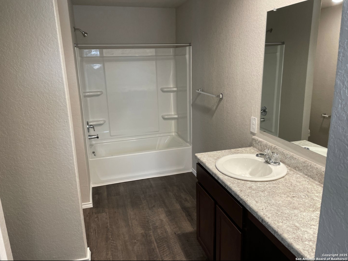 13128 Candace Way St. Hedwig, TX 78152 - Photo 9 of 14 a bathroom with a granite countertop sink a mirror and a bathtub