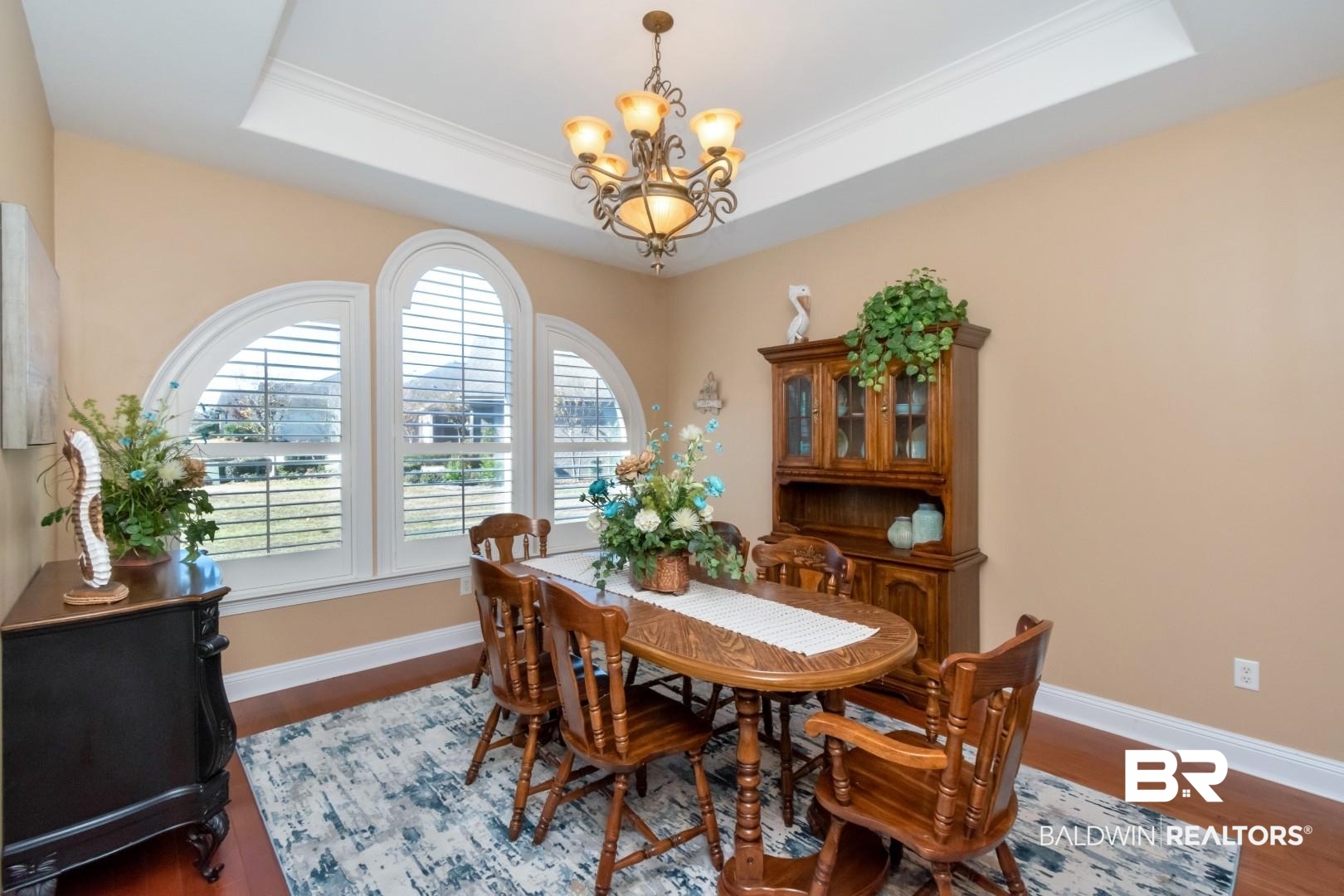 9905 Carnoustie Court Foley, AL 36535 - Photo 3 of 31 Dining room with wood finished floors, a chandelier, and a raised ceiling