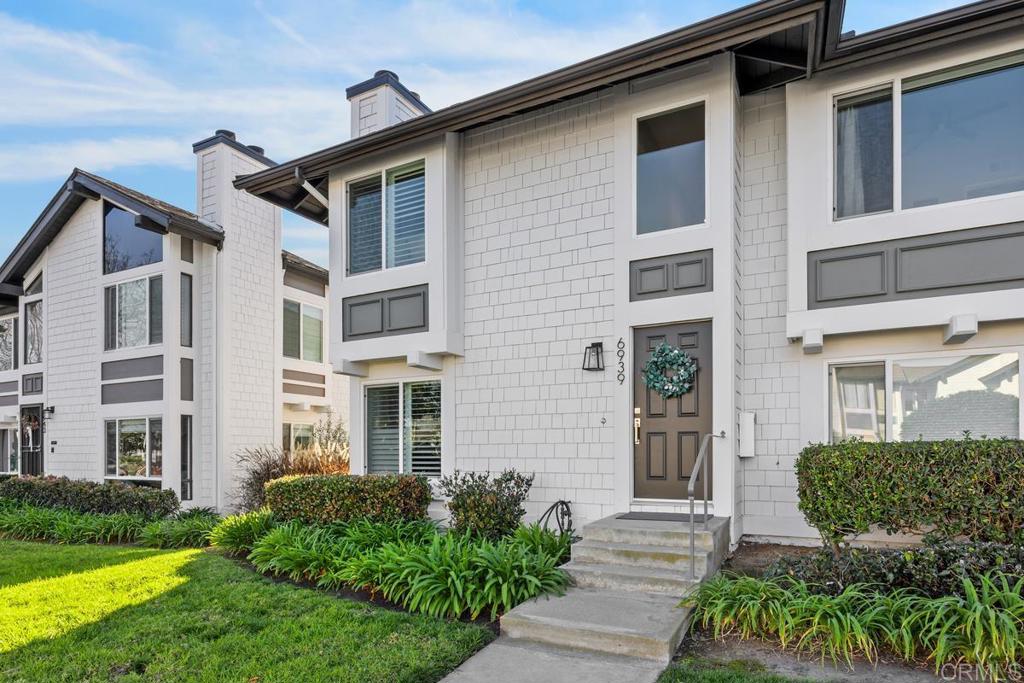 6939 Carnation Drive Carlsbad, CA 92011 - Photo 2 of 13 a front view of a house with garden