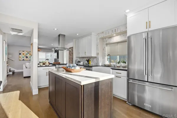 a kitchen with a refrigerator a sink and a stove