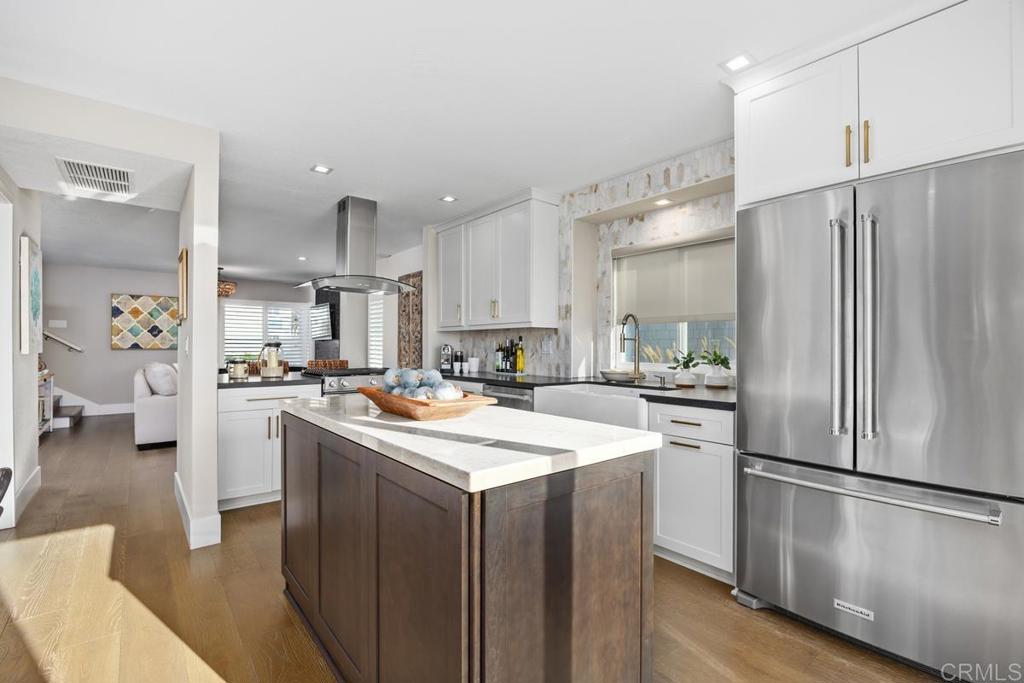 6939 Carnation Drive Carlsbad, CA 92011 - Photo 5 of 13 a kitchen with a refrigerator a sink and a stove