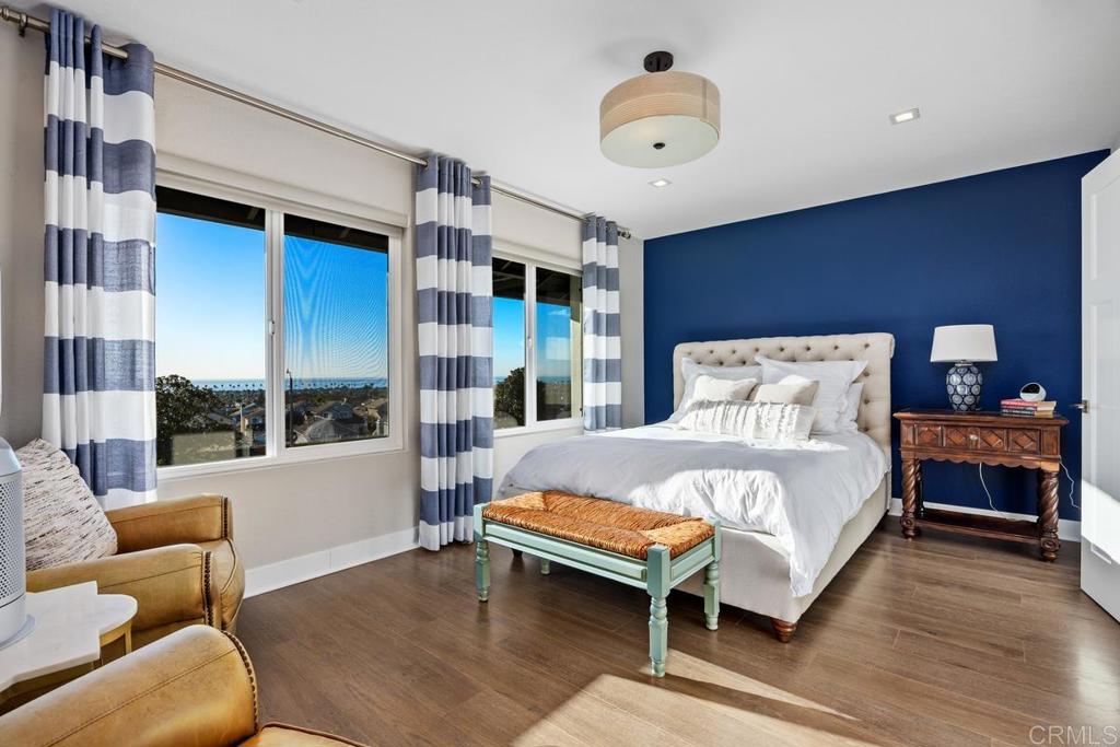 6939 Carnation Drive Carlsbad, CA 92011 - Photo 9 of 13 a bedroom with a bed and a large window with balcony view