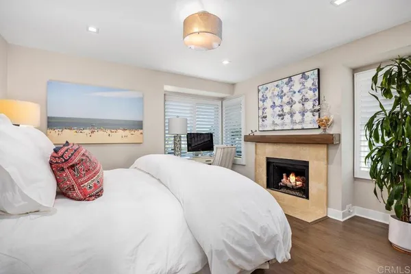 a bedroom with a bed and a fireplace