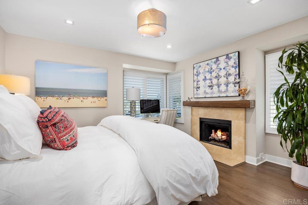 6939 Carnation Drive Carlsbad, CA 92011 - Photo 10 of 13 a bedroom with a bed and a fireplace